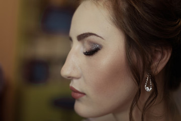 bride. girl in profile. makeup close-up. closed eyes.