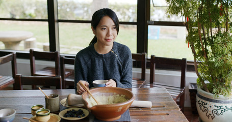 Woman drinking Chinese ground tea