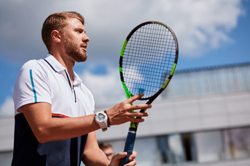 Tennis match which a serving player, keeping his eye on the ball.
