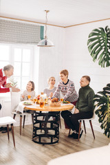 awesome hardworking woman has orginezed happy thanksgiving day. family is giving thanks during the dinner
