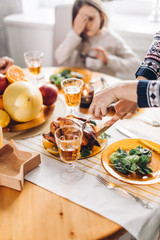 woman is putting turkey on the plate,yummy treatment for visitors. tasty recipe from grandmother