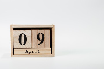 Wooden calendar April 09 on a white background