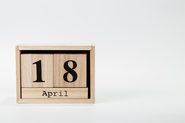 Wooden calendar April 18 on a white background