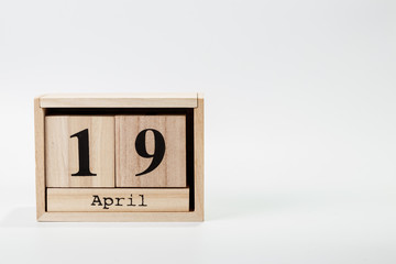 Wooden calendar April 19 on a white background