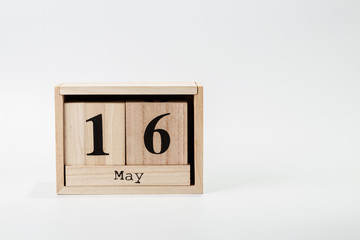 Wooden calendar May 16 on a white background