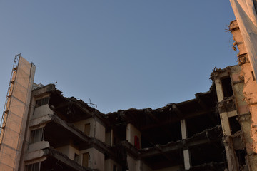 Obraz premium 夕方の日本の岡山の重機で解体中の白いビル