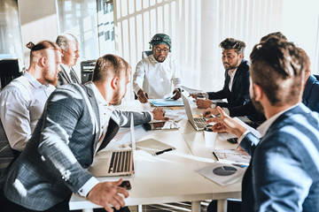 multiracial meeting with foreign sponsors. company studing finance