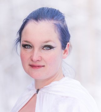 Lady in blue in midst of finnish winter forest