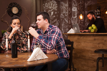 Happy couple drinking wine when having date in restaurant. Beautiful couple.