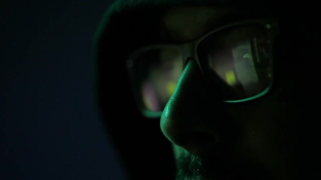 american man glasses hacker face in black background. male programmer professional adult cyber security in control room. concept global digital developer eyeglasses work online dark data technology