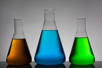 Liquid in laboratory bottles. Scientific biochemical laboratory. Colorful liquid.