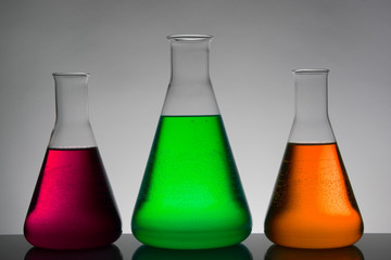Liquid in laboratory bottles. Scientific biochemical laboratory. Colorful liquid.