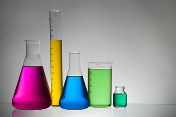 Liquid in laboratory bottles. Scientific biochemical laboratory. Colorful liquid.