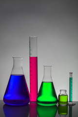 Liquid in laboratory bottles. Scientific biochemical laboratory. Colorful liquid.