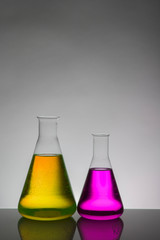 Liquid in laboratory bottles. Scientific biochemical laboratory. Colorful liquid.