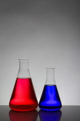 Liquid in laboratory bottles. Scientific biochemical laboratory. Colorful liquid.
