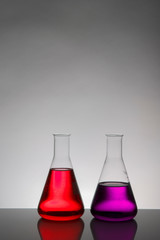 Liquid in laboratory bottles. Scientific biochemical laboratory. Colorful liquid.