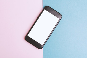 Work place, pink, blue. Image of smartphone with blank white screen, Flat lay, top view