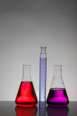 Liquid in laboratory bottles. Scientific biochemical laboratory. Colorful liquid.