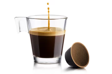 Foto auf Acrylglas Black coffee in glass cup with coffee waffle and jumping drop on white background © winston