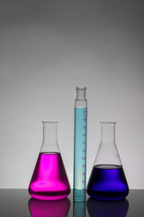 Liquid in laboratory bottles. Scientific biochemical laboratory. Colorful liquid.