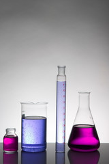 Liquid in laboratory bottles. Scientific biochemical laboratory. Colorful liquid.