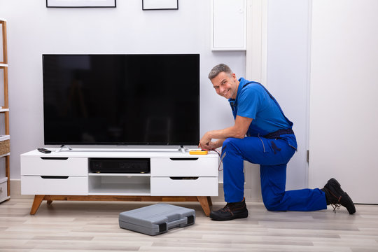 Technician Checking Television