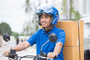Delivery boy on motorcycle with trunk parcel box driving to fast in rush. Courier delivering order online. Express delivery within specified time by scooter concept - obrazy, fototapety, plakaty