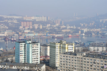 Russia. Winter Vladivostok in a haze. In the foreground street Okatovaya