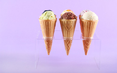 Assorted flavor ice cream in cones
