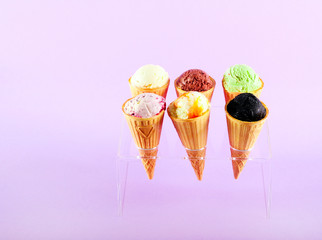 Assorted flavor ice cream in cones