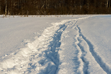 Path in a snowy field, rural landscape