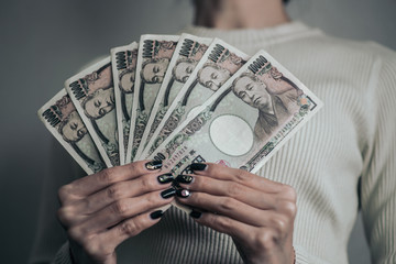 一万円札を持つ女性