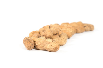 Raw tasty peanuts on white background