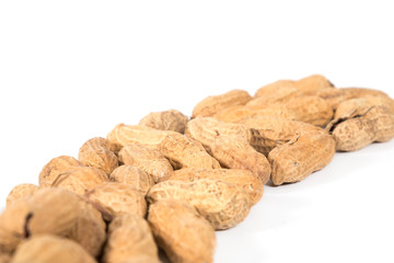 Raw tasty peanuts on white background