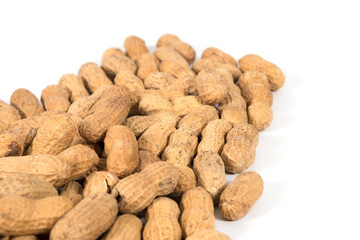 Raw tasty peanuts on white background