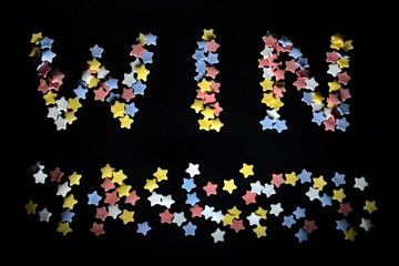 Thw word Win in red white yellow and blue sugar stars, for business, coaching, sports fans, success, winning