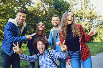 Friends walk laughing in the park.