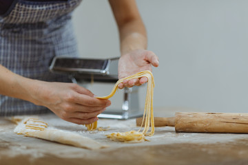 Housewife makes noodles with a special device. New generation