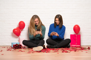 Couple in valentine day sending a message with the mobile