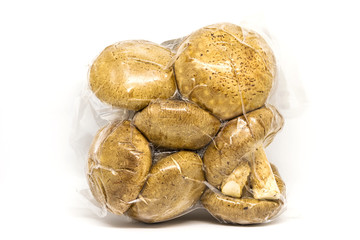 Fresh Shiitake mushroom in vacuum package isolated on white background.
