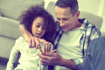 Intelligent parent teaching his curious girl how to count.