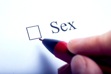 Sex - checkbox with a cross on white paper with pen. Checklist concept.