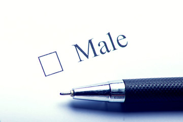 Male - checkbox with a cross on white paper with pen. Checklist concept.