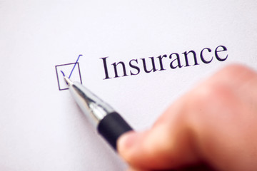 Checklist with a word Insurance on white paper. Checkbox concept.