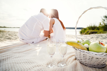 Young couple is holding hands at the beach on a sunny day.