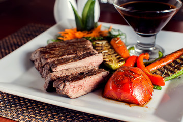 Beef steak with grilled vegetables served on white plate. Food concept