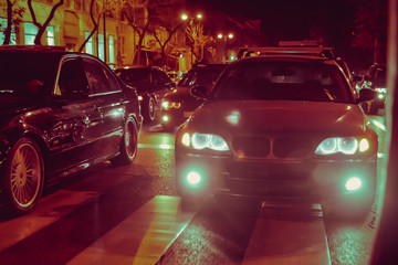 Night view of the cars. Road in the city at the night with yellow and red electrical light for cars during they are coming home. The cars compete at night. Only the lights of night carriages.