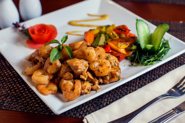 Chicken Marengo - French dish consisting of a chicken and shrimps with garlic and tomato. Food and restaurant concept
