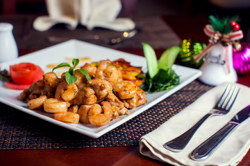 Chicken Marengo - French dish consisting of a chicken and shrimps with garlic and tomato. Food and restaurant concept